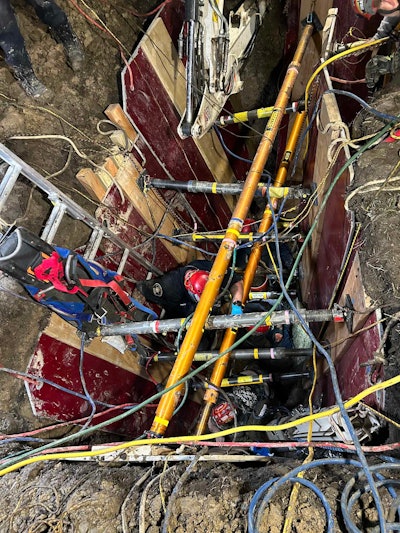 Emergency responders work to rescue workers trapped in trench collapse in Michigan