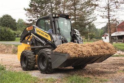 New Holland L328 carrying bucketful of hay