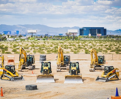 machines lined up in a sandbox