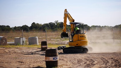 man operates a kobelco machine
