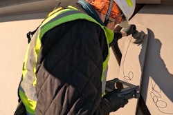 man uses ultrasonic tech to inspect a bridge