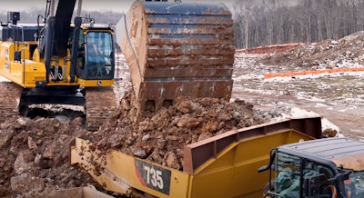 Craig LoadMax 6-yard Bucket on Deere 470 P-Tier excavator Loading Cat 735 articulated dump truck with clay dirt