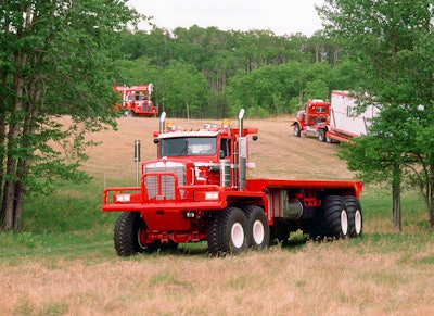 red Kenworth C500 twin steer truck with empty bed