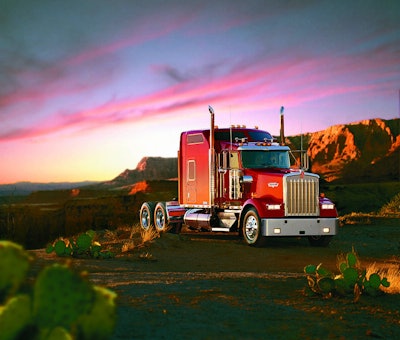 red Kenworth W900L truck in desert under purplish sunset sky