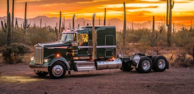 green Kenworth 2026 W900 Legacy Edition in desert golden sky and cactus in background