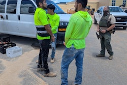 Workers are cuffed and detained at the construction site for a future high school in Gulf Shores, Alabama, June 24.