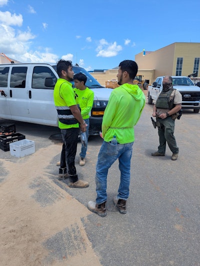 Workers are cuffed and detained at the construction site for a future high school in Gulf Shores, Alabama, June 24.