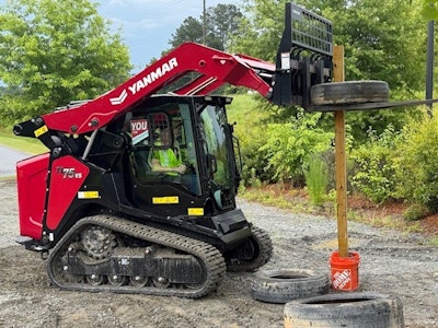 Equipment World Chief Editor Jordanne Waldschmidt demonstrates stacking tires using an automatic self-leveling feature on Yanmar's new compact track loader line as part of a Y.O.U. Club challenge.