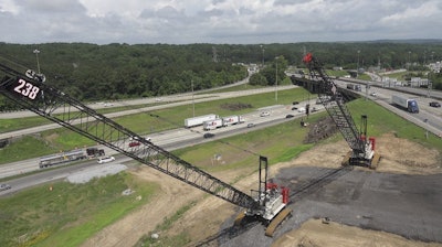 Two cranes have already been positioned within the loop ramp from I-20 eastbound to I-285 northbound to begin construction.
