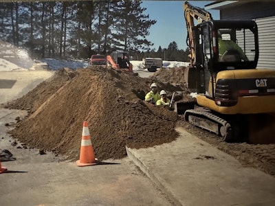 Bennett and Belongia lay a sewer line in Mancelona, Michigan, in 2011.