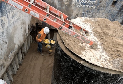 Compacting backfill with a BOMAG BT65 Tamper