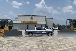 An APEX Technologies truck in front of a McCoy Construction store.