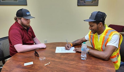 Jahwon Hartsfield (right) was recently hired as a transportation worker by NCDOT.