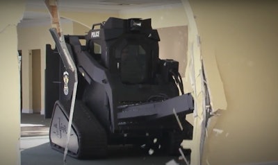 The Rook's Hydraulic Breaching Ram attachment can extend 6 to 10 feet to knock through block walls, reinforced steel doors, wood and concrete, hurricane windows and windows protected by burglar bars, the company says.