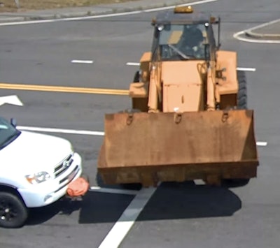 The brakes failed on the loader as it narrowly misses hitting a truck stopped August 15 at an intersection in Milford, Massachuestts.