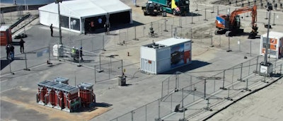 Hitachi Energy's zero-emissions construction test site consists of the HyFlex hydrogen fuel-cell generator (center right) and Hitachi's largest electric excavator, the ZE135 (right).