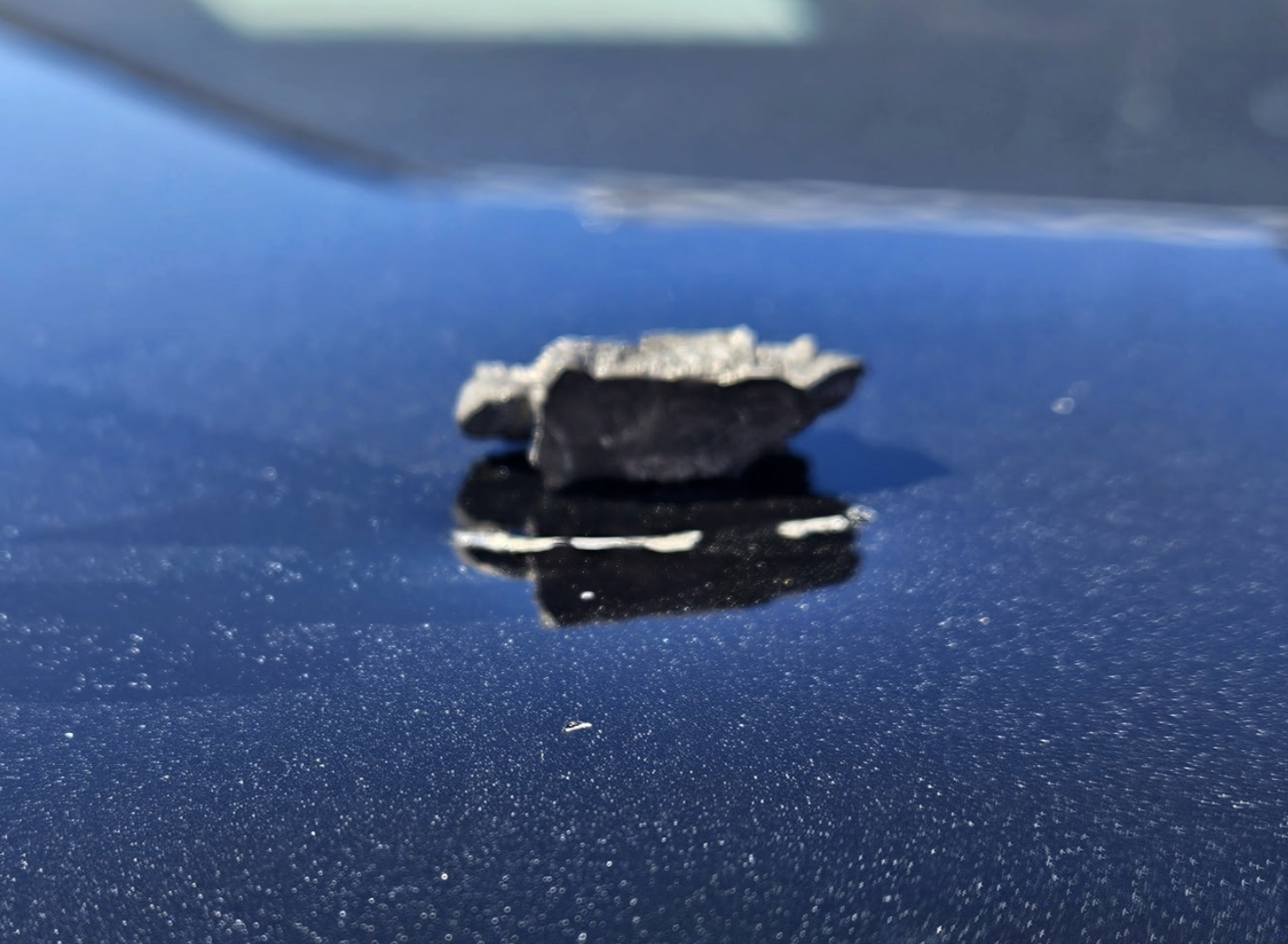 A piece of shrapnel after striking the hood of a California Highway Patrol vehicle
