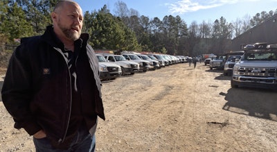 Kristopher Kornegay outlines the day's projects as crews behind him prepare to head out.