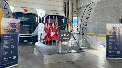 Nikola electric truck on display with Canadian flags at indoor event