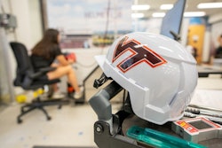 A researcher performs tests in the Virginia Tech Helmet Lab, which has released the first-ever construction helmet ratings.
