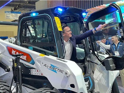 A look at Bobcat's CES booth in 2024, featuring a concept transparent Organic Light Emitting Diode touch display on a S7X electric skid steer loader.