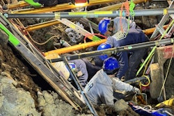Hamilton County Urban Search & Rescue Region 6 members work December 5 to remove workers trapped in a collapsed trench in Miami Township, Ohio.