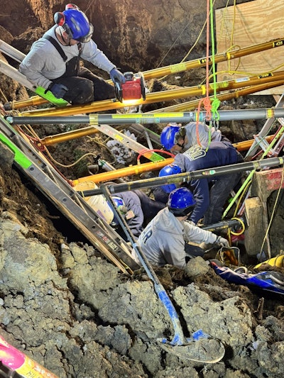 Hamilton County Urban Search & Rescue Region 6 members work December 5 to remove workers trapped in a collapsed trench in Miami Township, Ohio.