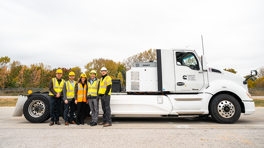 Purdue professors pose with a prototype electric Cummins heavy-duty truck.