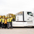 Purdue professors pose with a prototype electric Cummins heavy-duty truck.