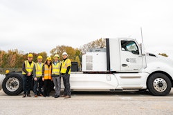 Purdue professors pose with a prototype electric Cummins heavy-duty truck.