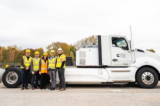 Purdue professors pose with a prototype electric Cummins heavy-duty truck.