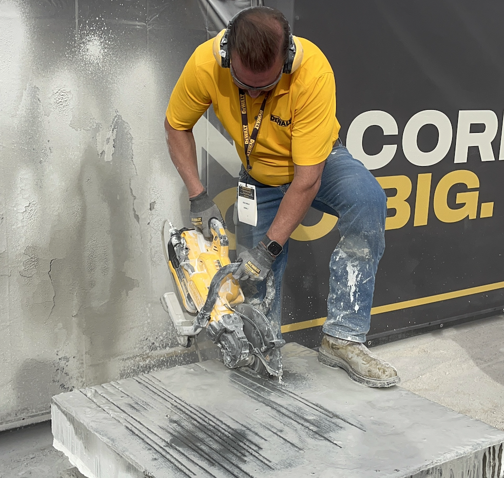 A DeWalt booth representative demos the company's new DCPS612AG2 12-inch cut-off saw