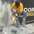 A DeWalt booth representative demos the company's new DCPS612AG2 12-inch cut-off saw