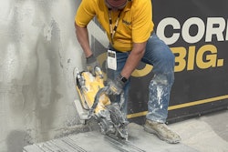 A DeWalt booth representative demos the company's new DCPS612AG2 12-inch cut-off saw