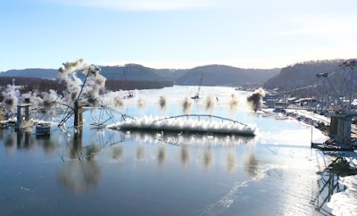 The Black Hawk Bridge falling into the Mississippi River.