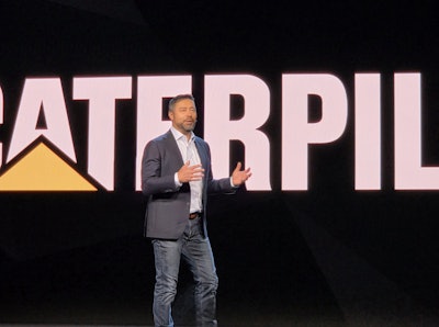 Caterpillar CEO Joe Creed unveils the company's new Cat AI Assistant at a keynote address during CES 2026 in Las Vegas.