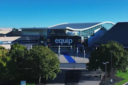 Modern glass conference center with 'Equip' signage and blue entrance walkway