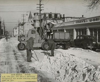 A Scoopmobile can be seen in the background loading a truck with snow in Portland, Oregon, on February 2, 1950.