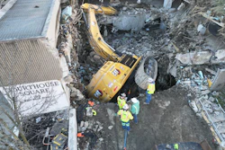 This Cat 352 fell into a hole during a parking garage demolition March 3 in Washington, Pennsylvania. The 'world's largest rolling rotator' and a specially designed Deere excavator with crane from Bill's Towing & Recovery came to the rescue.
