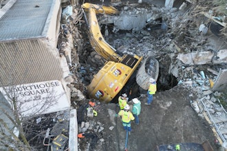This Cat 352 fell into a hole during a parking garage demolition March 3 in Washington, Pennsylvania. The 'world's largest rolling rotator' and a specially designed Deere excavator with crane from Bill's Towing & Recovery came to the rescue.