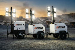 Three ECHO portable light towers with LED lighting arrays positioned on a construction site at sunset