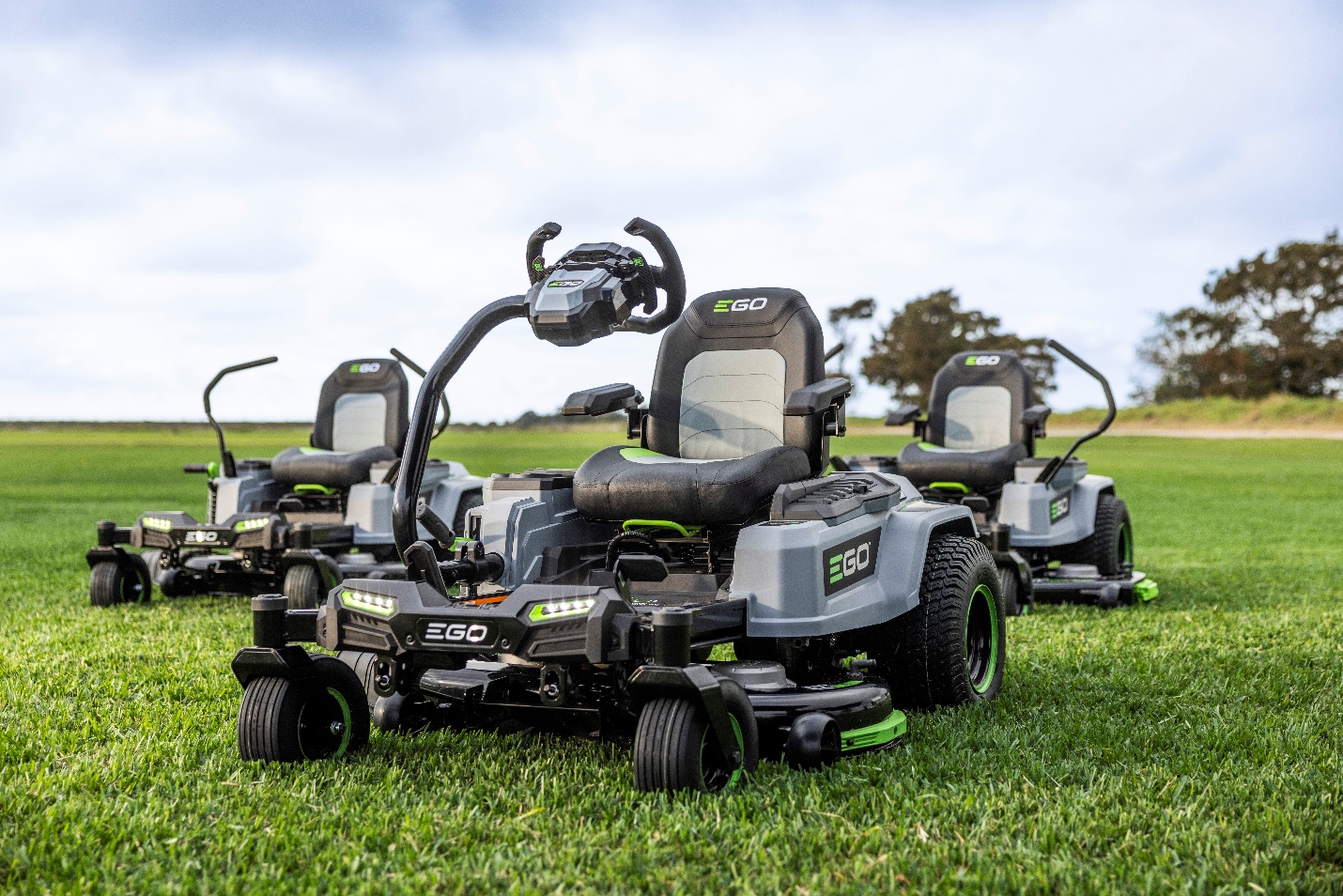 Collection of EGO zero-turn radius lawn mowers displayed on green grass field