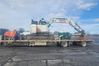 This 2019 Freightliner toting a Bobcat excavator was stopped in Salina after allegedly striking more than a dozen bridges on the New York Thruway.