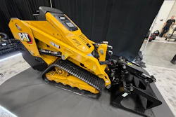 Yellow Caterpillar TH100 tracked skid steer loader with bucket attachment on display