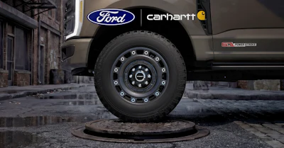 Ford truck with Carhartt collaboration branding parked on wet urban street with industrial building backdrop