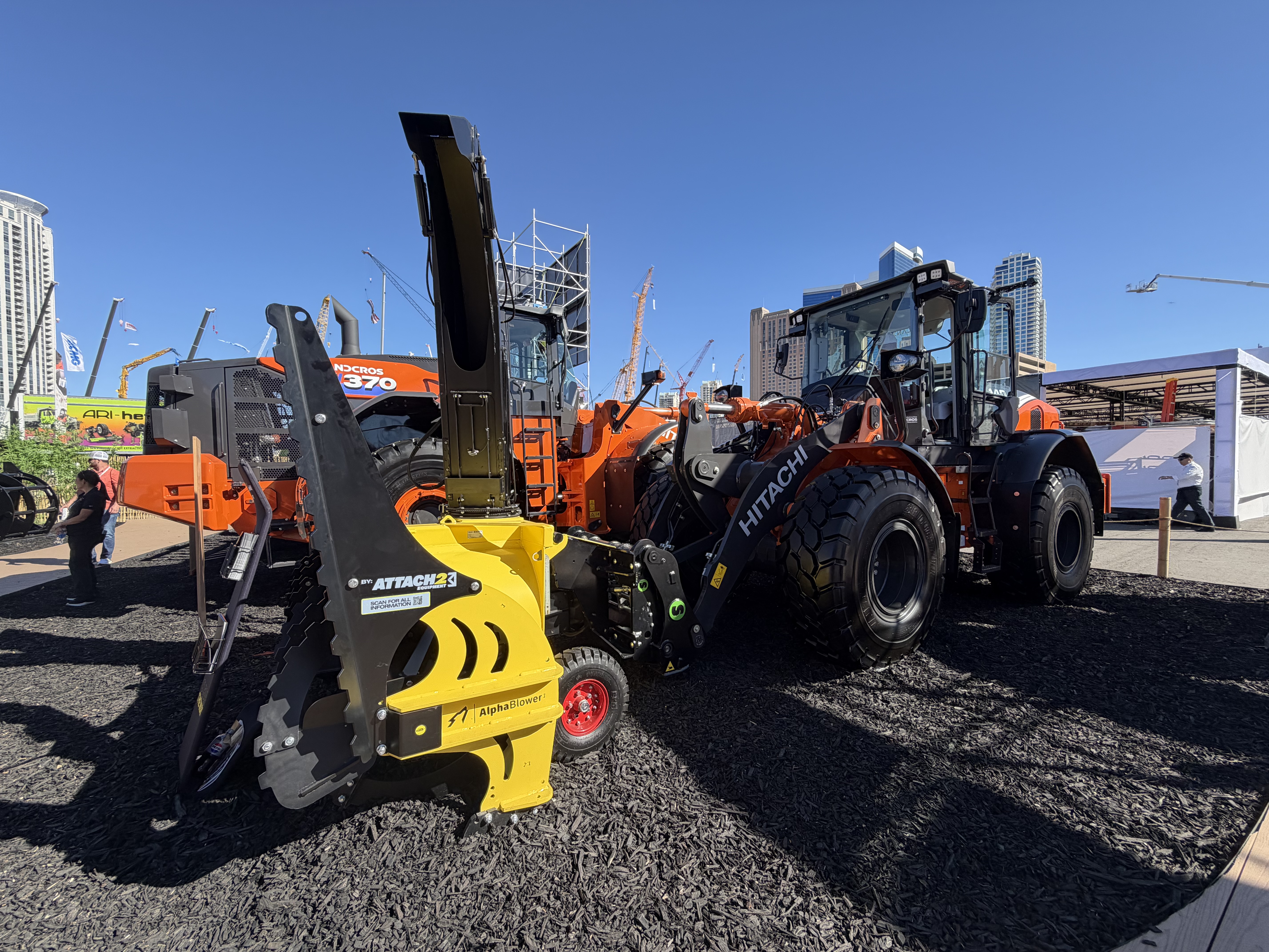 Hitachi ZW140-7 wheel loader equipped with a Steelwrist SQL50 automatic quick coupler and a snowblower attachment.