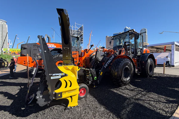 Hitachi ZW140-7 wheel loader equipped with a Steelwrist SQL50 automatic quick coupler and a snowblower attachment.