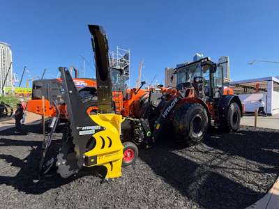 Hitachi ZW140-7 wheel loader equipped with a Steelwrist SQL50 automatic quick coupler and a snowblower attachment.