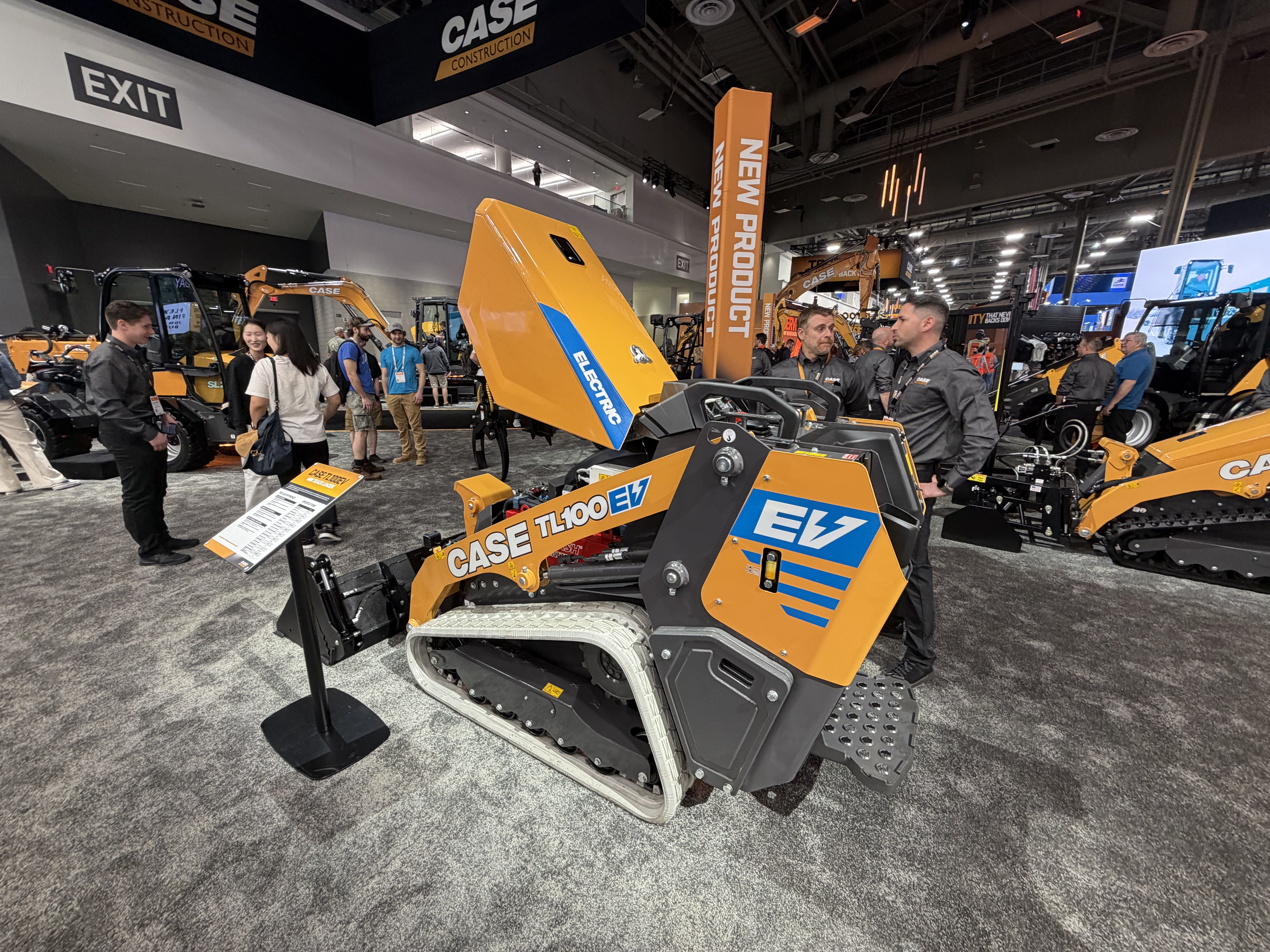 CASE TL100 EV compact track loader displayed at construction equipment trade show with visitors