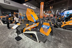 CASE TL100 EV compact track loader displayed at construction equipment trade show with visitors